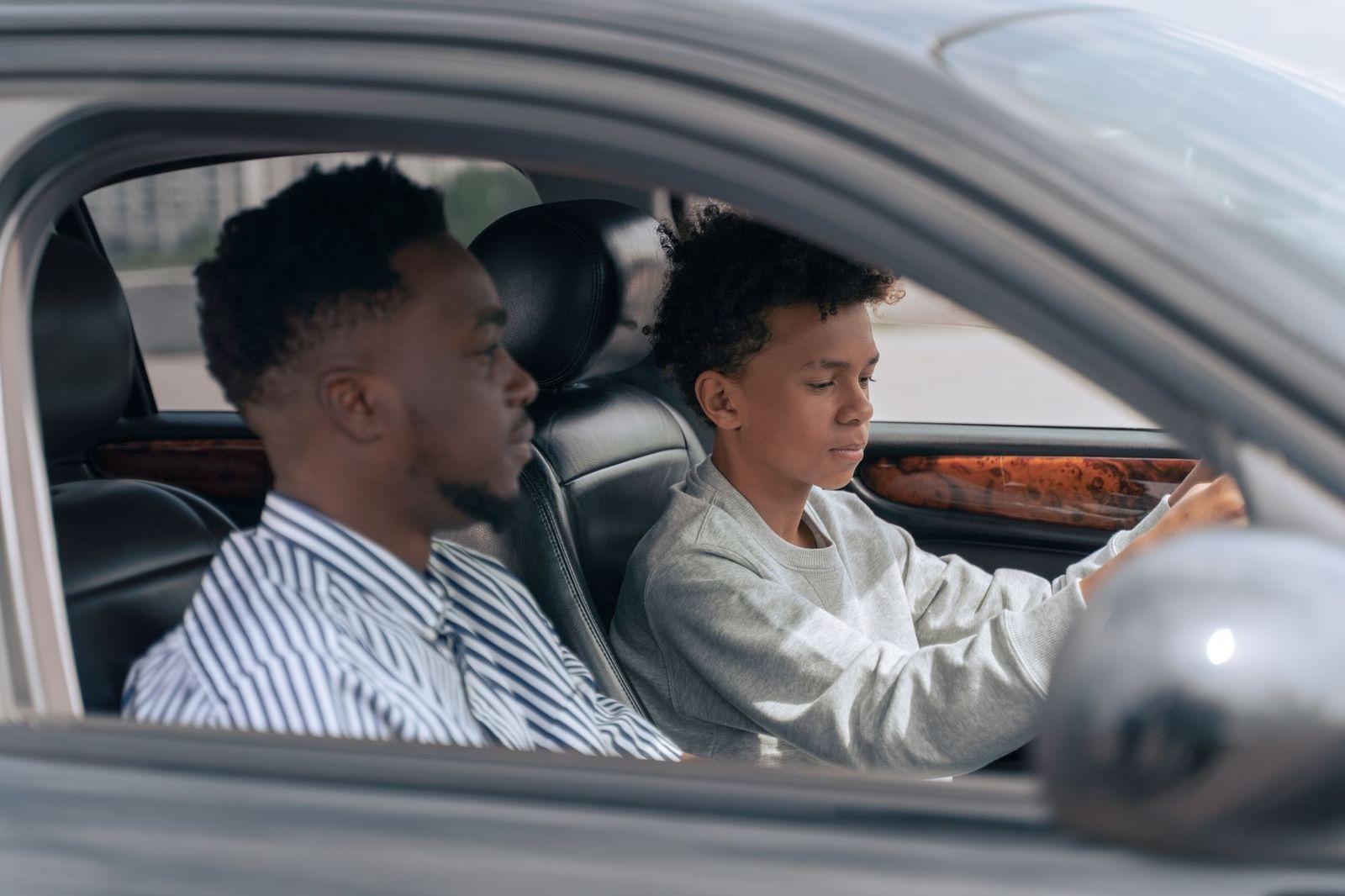 An instructor giving feedback to a learner driver during a lesson